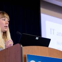 Scholar giving oral presentation.